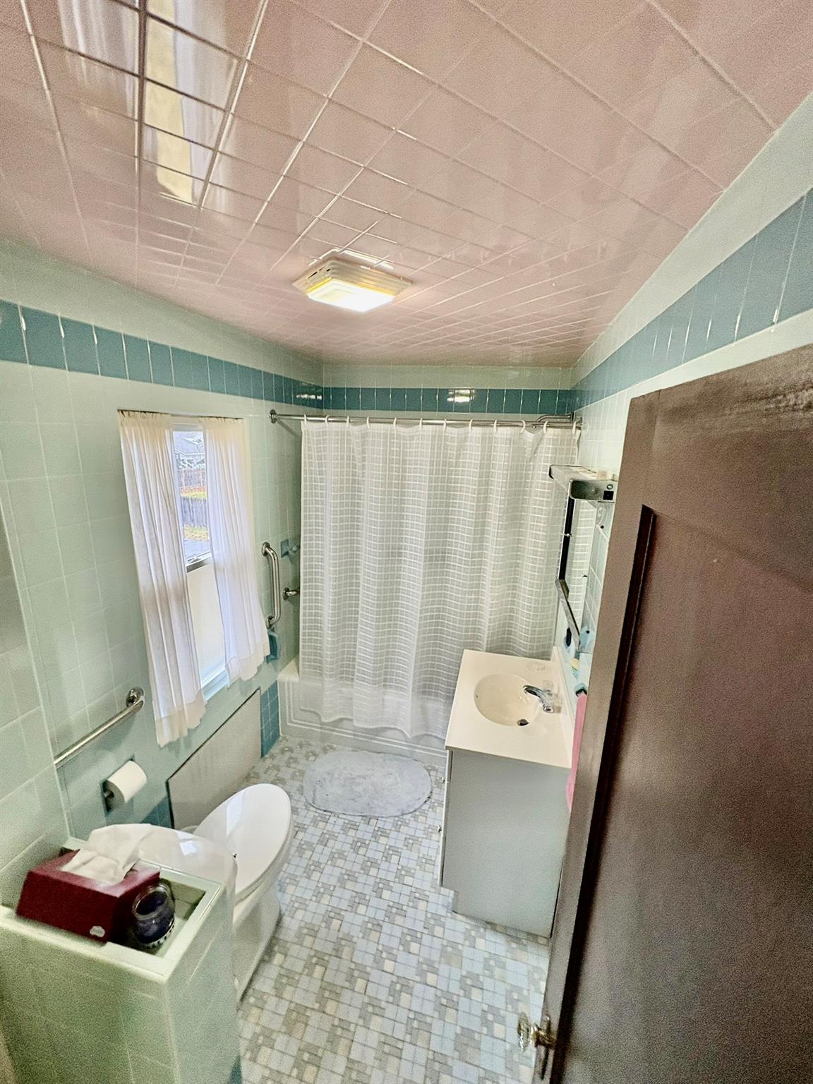 123 Rockland Road Roscoe, NY 12776 - Photo 21 of 31 Full bathroom with toilet, vanity, tiled shower / bath, and tile walls