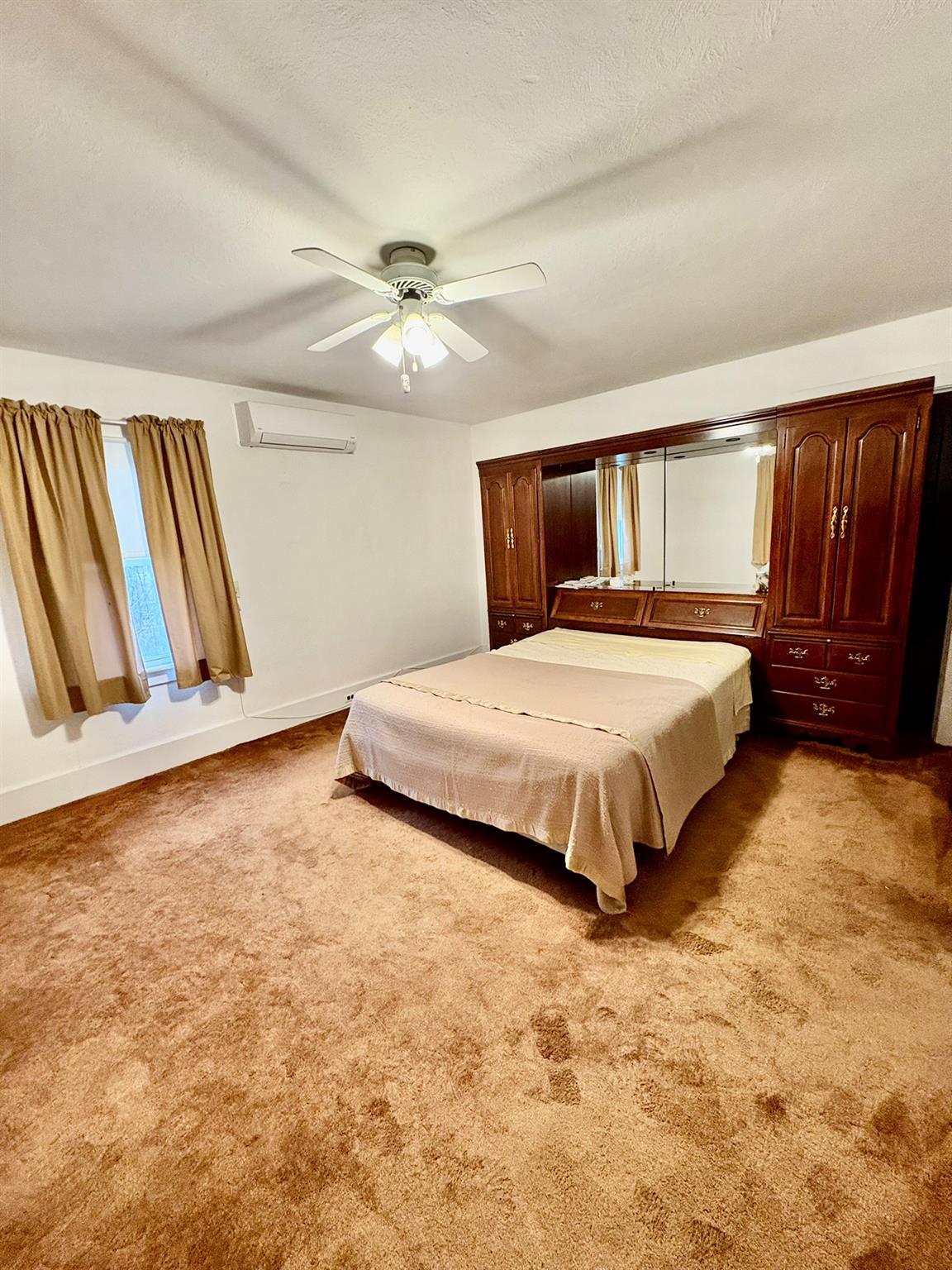 123 Rockland Road Roscoe, NY 12776 - Photo 28 of 31 Bedroom with baseboards, a wall mounted AC, carpet flooring, and a textured ceiling