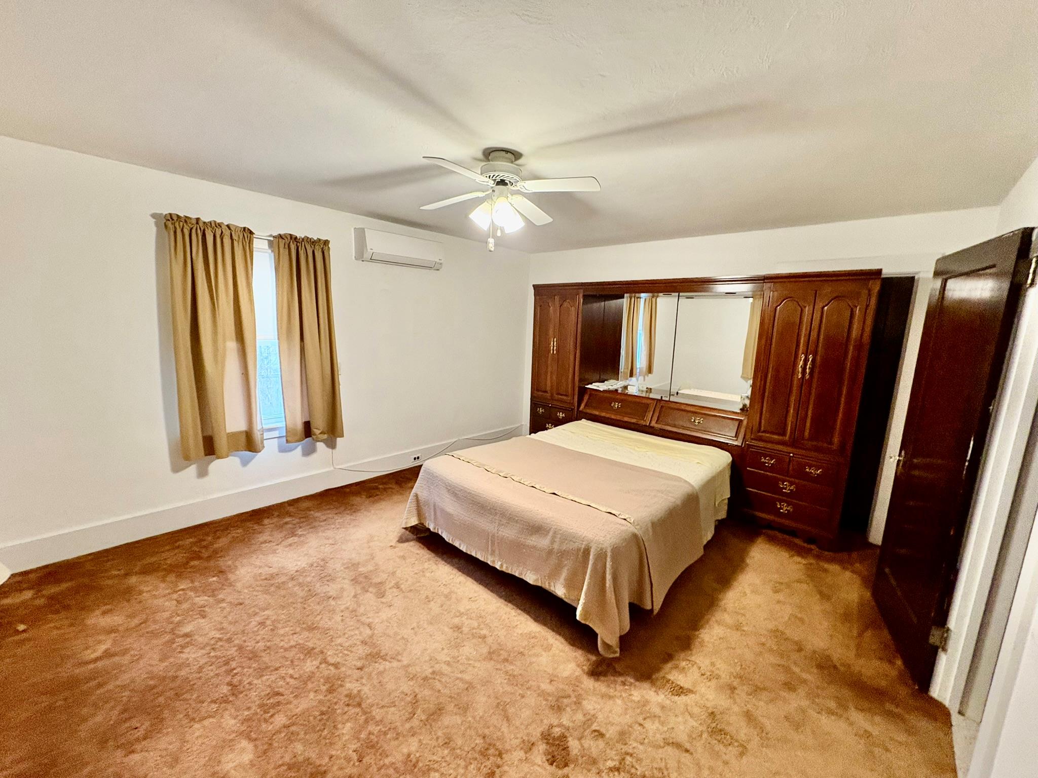 123 Rockland Road Roscoe, NY 12776 - Photo 29 of 31 Carpeted bedroom featuring baseboards, a wall mounted AC, and a ceiling fan