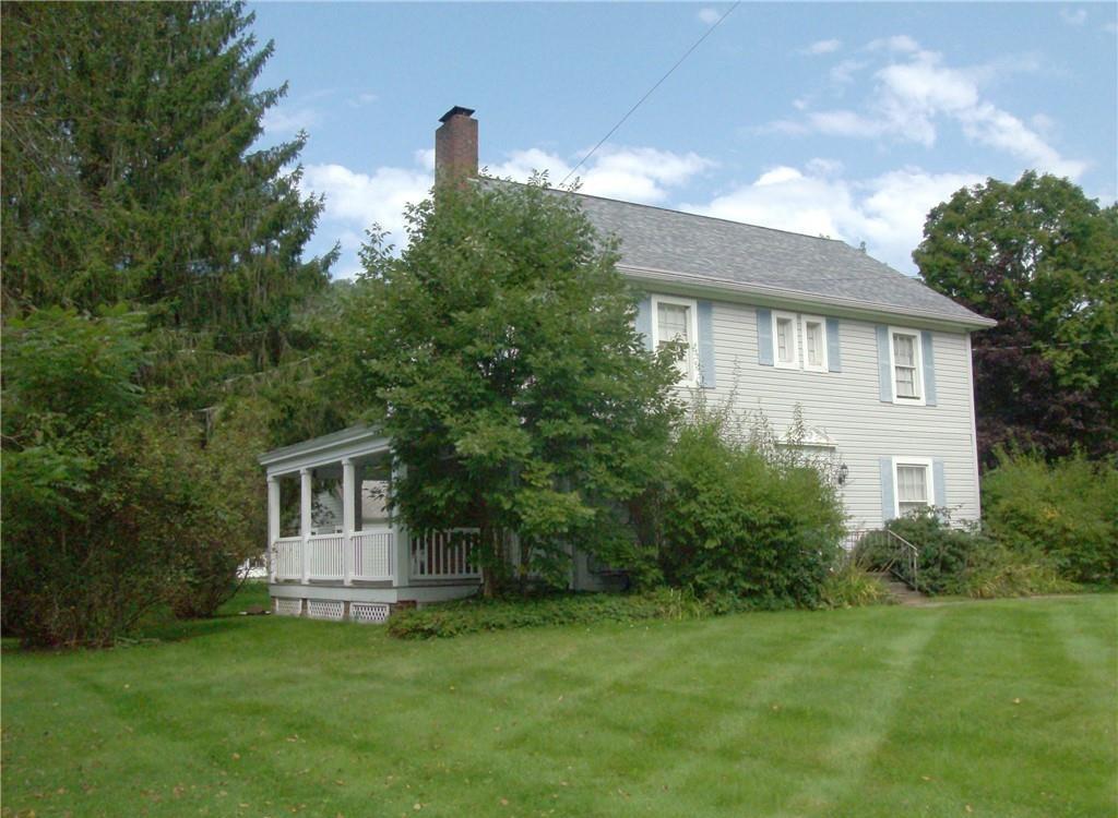 123 Rockland Road Roscoe, NY 12776 - Photo 31 of 31 View of property exterior featuring a lawn, a sunroom, a chimney, and a shingled roof