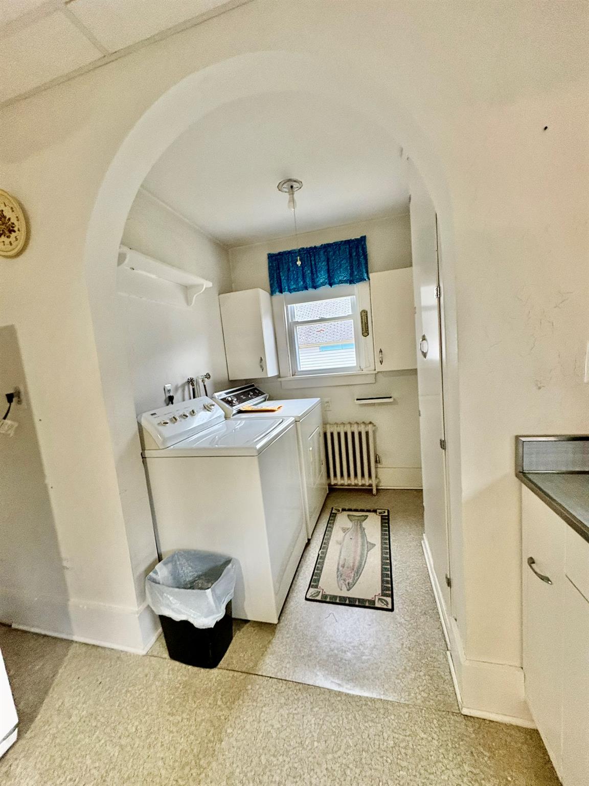 123 Rockland Road Roscoe, NY 12776 - Photo 5 of 31 Washroom with baseboards, washing machine and clothes dryer, arched walkways, radiator heating unit, and cabinet space