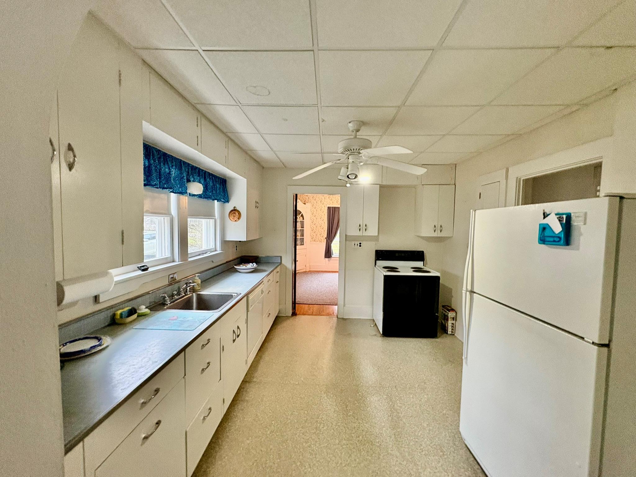 123 Rockland Road Roscoe, NY 12776 - Photo 6 of 31 Kitchen featuring a sink, electric range oven, freestanding refrigerator, light floors, and a paneled ceiling