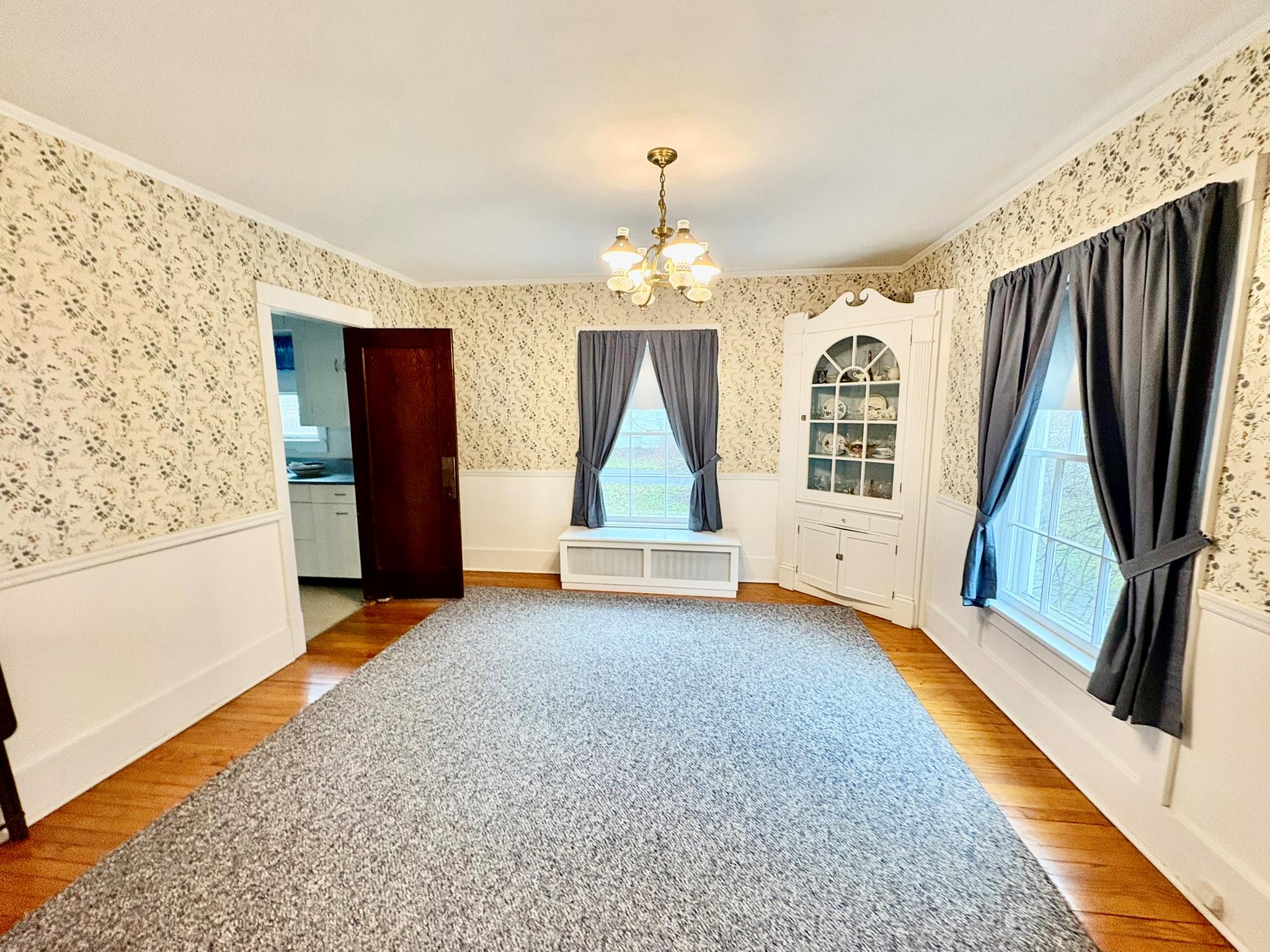 123 Rockland Road Roscoe, NY 12776 - Photo 10 of 31 inviting chandelier, wallpapered walls, radiator heating unit, and wainscoting