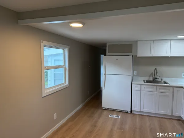 a kitchen with a refrigerator a sink and cabinets