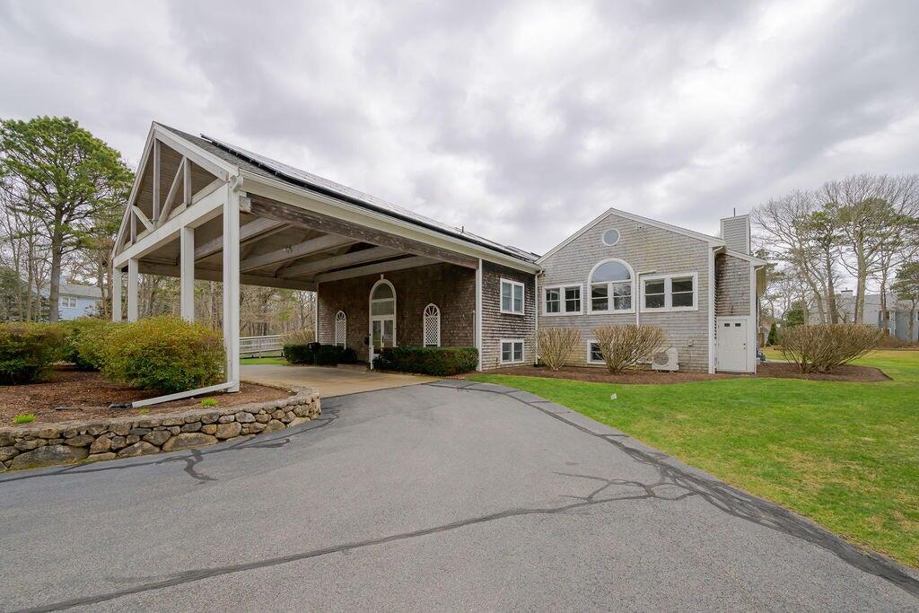 42 Eventide Lane Hyannis, MA 02601 - Photo 31 of 39 a front view of a house with a garden
