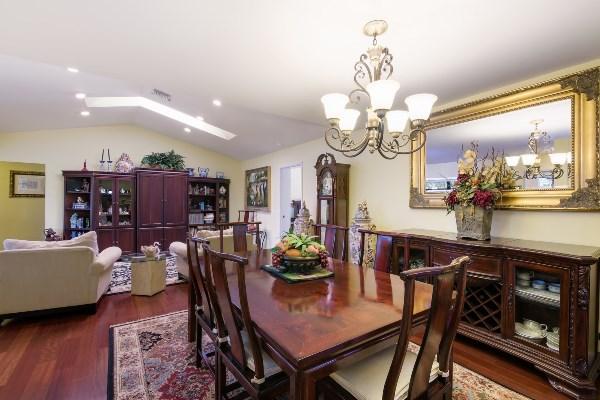 201 Oregon Lane Boca Raton, FL 33487 - Photo 17 of 31 a view of a dining room with furniture a chandelier and wooden floor