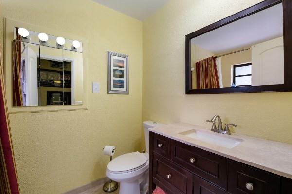 201 Oregon Lane Boca Raton, FL 33487 - Photo 22 of 31 a bathroom with a toilet sink and mirror