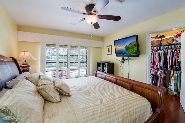 201 Oregon Lane Boca Raton, FL 33487 - Photo 23 of 31 a bedroom with a bed and a flat screen tv