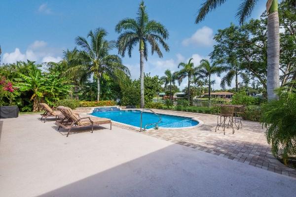 201 Oregon Lane Boca Raton, FL 33487 - Photo 27 of 31 a view of swimming pool with chairs and trees