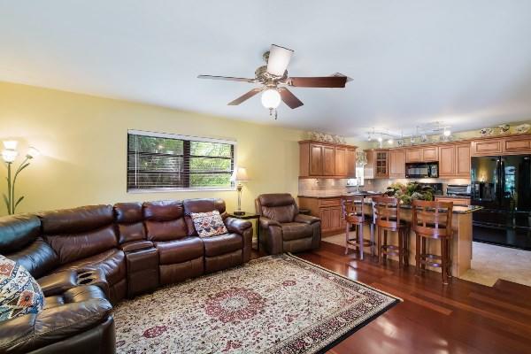 201 Oregon Lane Boca Raton, FL 33487 - Photo 10 of 31 a living room with furniture a rug and a window