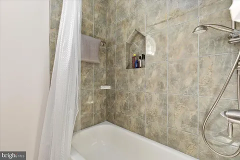 a bathroom with a granite countertop toilet sink and mirror