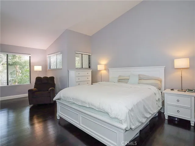 a bedroom with a bed and a night stand