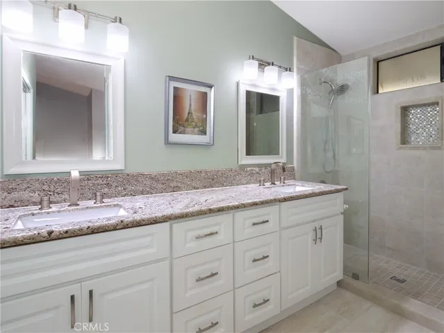 a bathroom with a granite countertop sink mirror and double