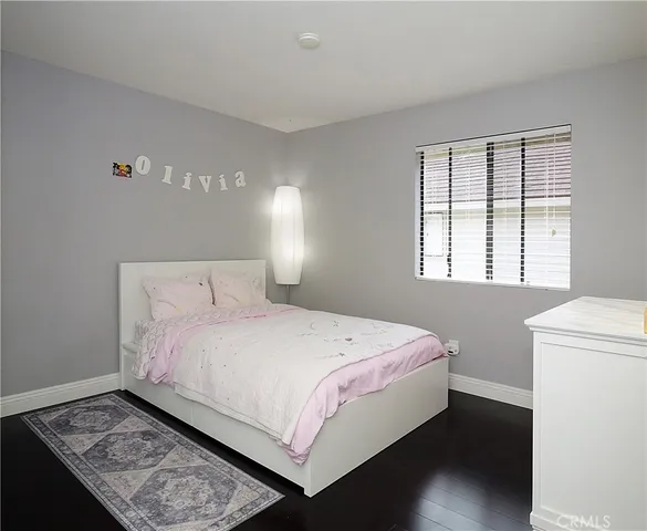 a bedroom with a bed and a night stand