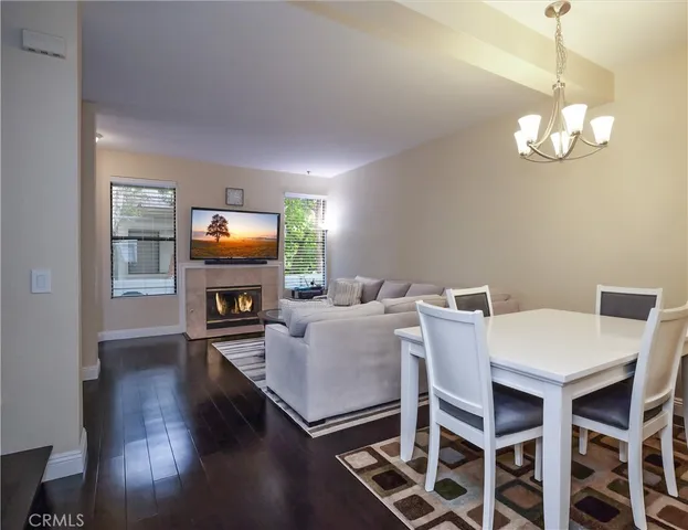 a view of a dining room with furniture wooden floor and chandelier