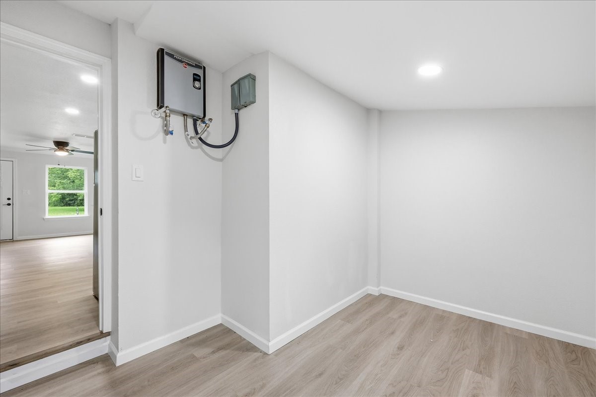5260 Landry Lane Beaumont, TX 77708 - Photo 12 of 25 Utility room, showcasing tankless water heater