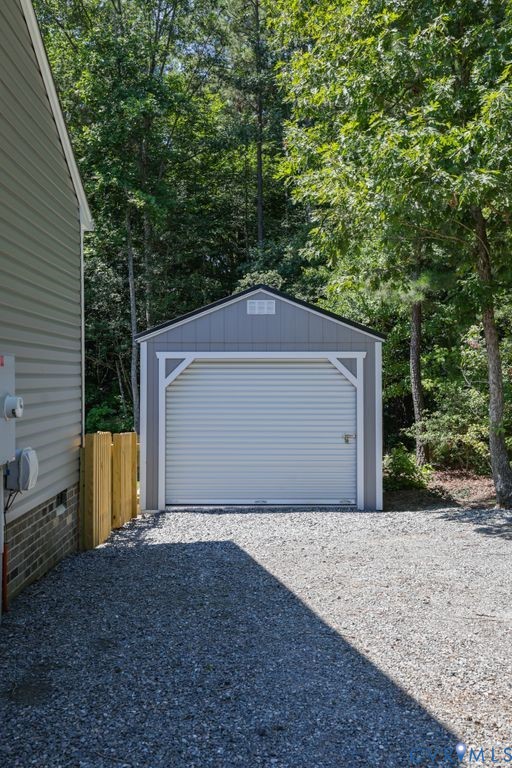 222 Oak Ridge Court Aylett, VA 23009 - Photo 35 of 35 Detached storage shed with a roll-up garage door,