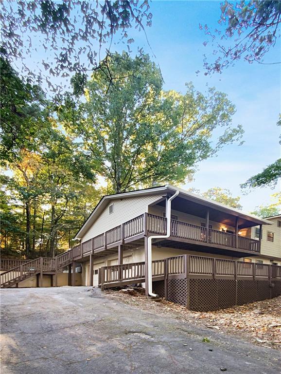 a view of a house with a large tree and a yard