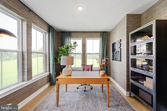 a living room with furniture a rug and a large window