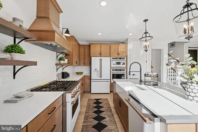 a kitchen with stainless steel appliances a sink stove and refrigerator