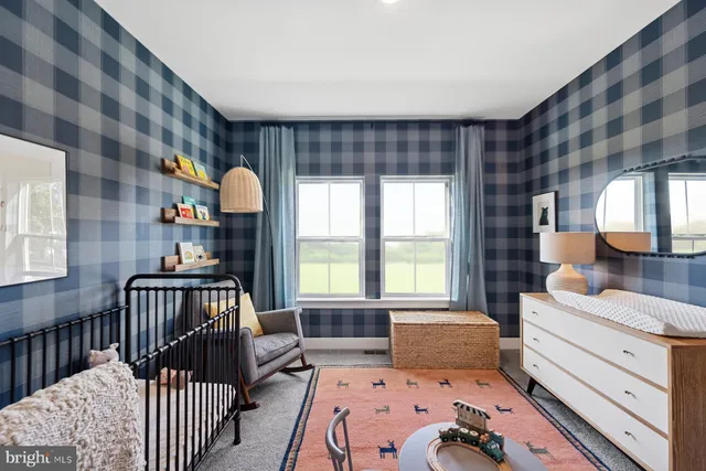 a bedroom with a bed table and a chair