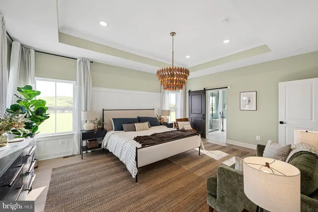 a bedroom with a bed and a chandelier