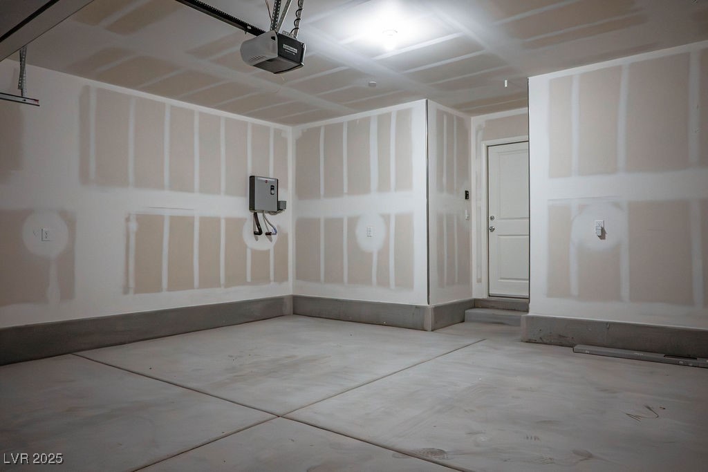 6184 Hibiscus Gdn Street North Las Vegas, NV 89081 - Photo 15 of 35 Garage featuring a garage door opener