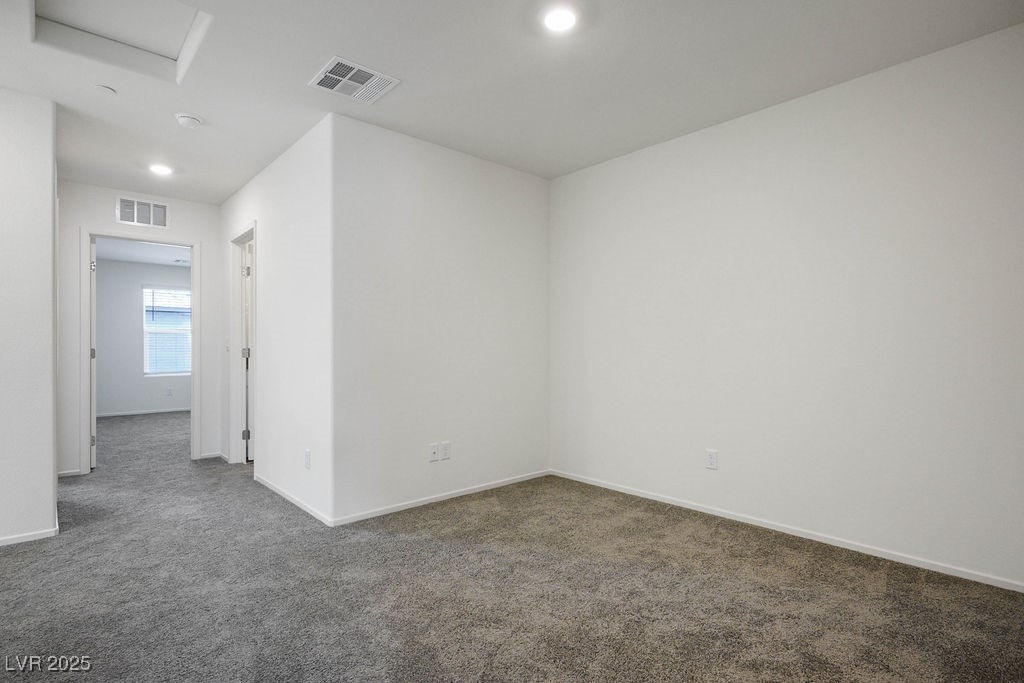 6184 Hibiscus Gdn Street North Las Vegas, NV 89081 - Photo 17 of 35 Empty room with dark carpet, recessed lighting, and attic access
