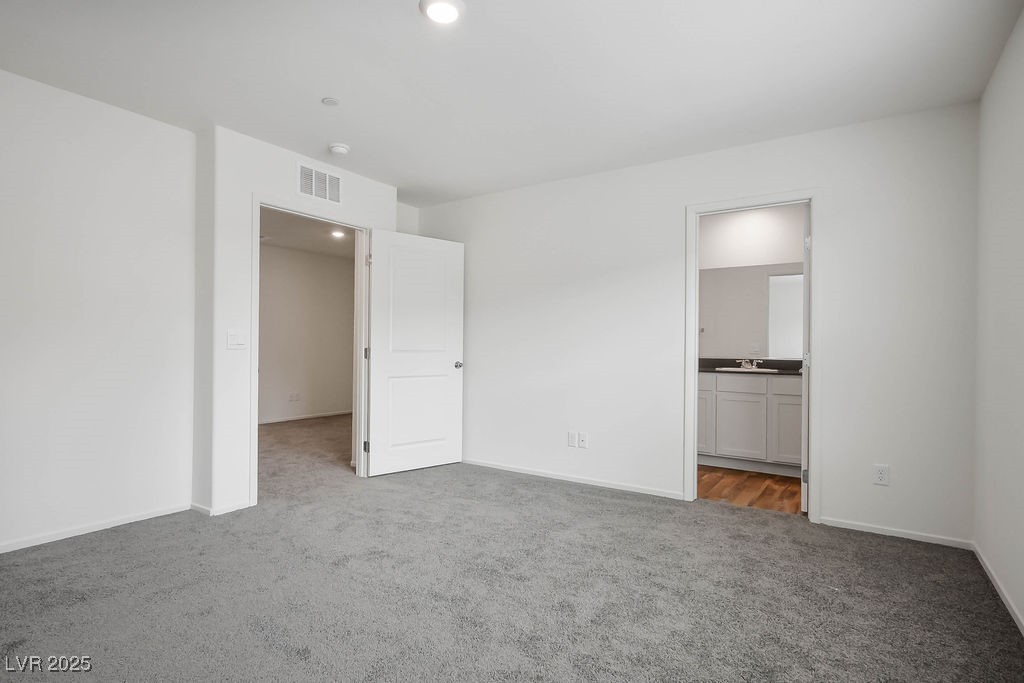 6184 Hibiscus Gdn Street North Las Vegas, NV 89081 - Photo 19 of 35 Unfurnished bedroom featuring light colored carpet and ensuite bathroom