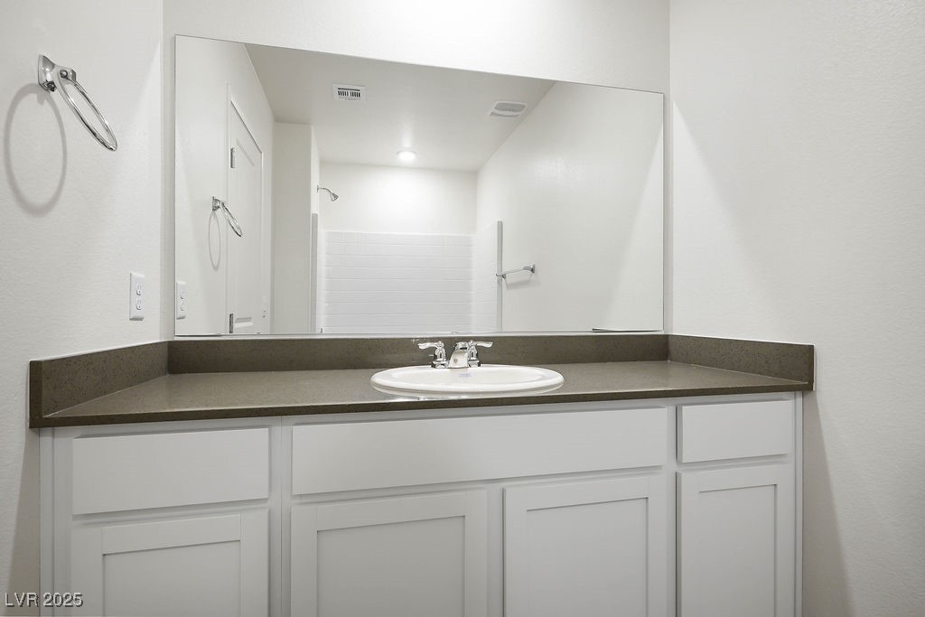 6184 Hibiscus Gdn Street North Las Vegas, NV 89081 - Photo 23 of 35 Bathroom with vanity and a shower