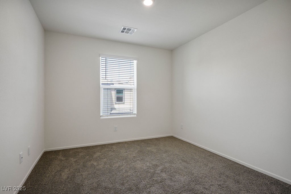 6184 Hibiscus Gdn Street North Las Vegas, NV 89081 - Photo 24 of 35 Spare room featuring dark colored carpet and baseboards