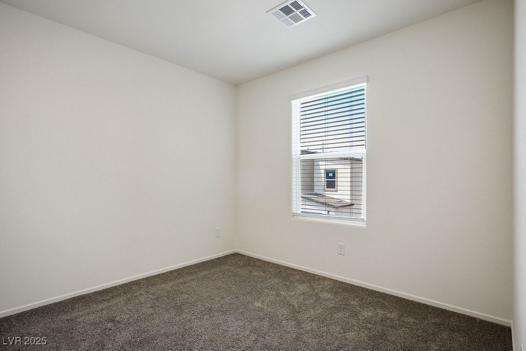 6184 Hibiscus Gdn Street North Las Vegas, NV 89081 - Photo 25 of 35 Empty room featuring baseboards and dark colored carpet
