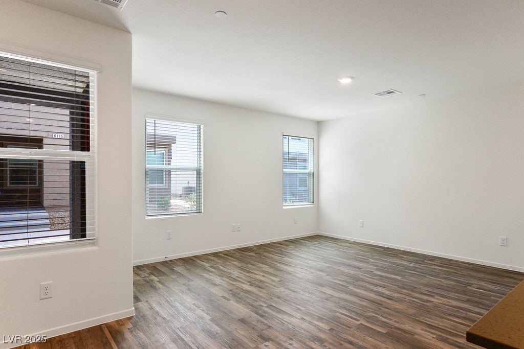 6184 Hibiscus Gdn Street North Las Vegas, NV 89081 - Photo 7 of 35 Empty room with dark wood-style floors and baseboards