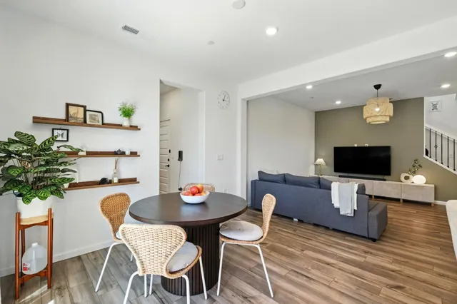 a view of a dining room with furniture and wooden floor