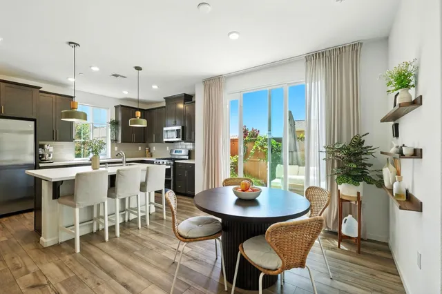 a kitchen with a dining table chairs and kitchen view