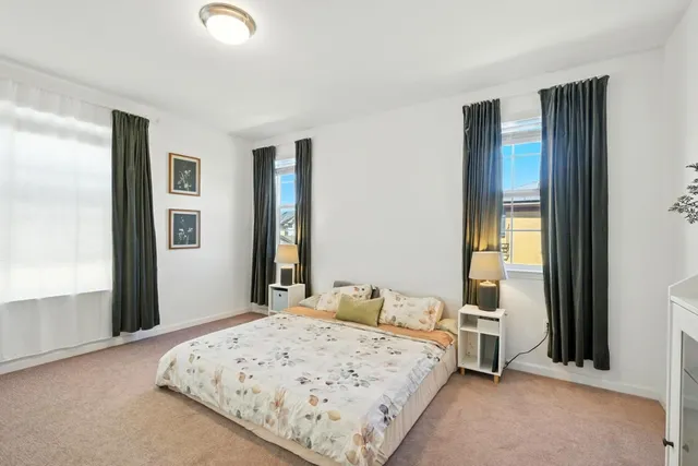 a bedroom with a large bed and a window