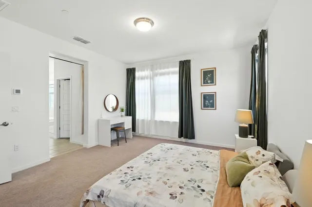 a bedroom with a bed and a window in it