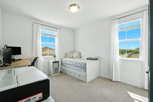 a bed room with a bed and a window