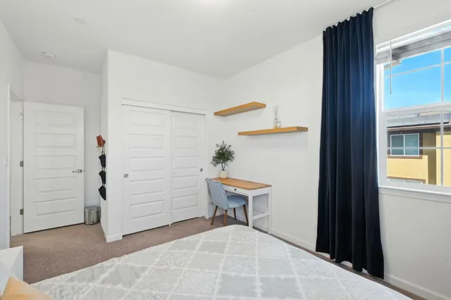 a view of a bedroom with a bench and cabinets