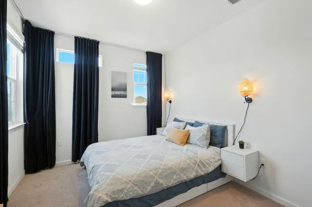 a bedroom with bed and window