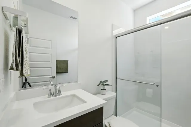 a bathroom with a sink toilet and shower