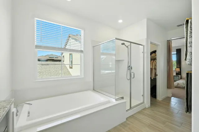 a bathroom with a bathtub and a shower