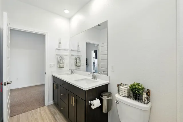 a bathroom with a sink a toilet and mirror