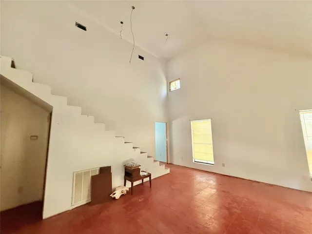 an empty room with windows and closet