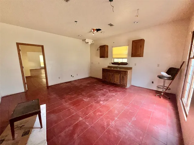 a view of a livingroom with a fireplace and a workspace