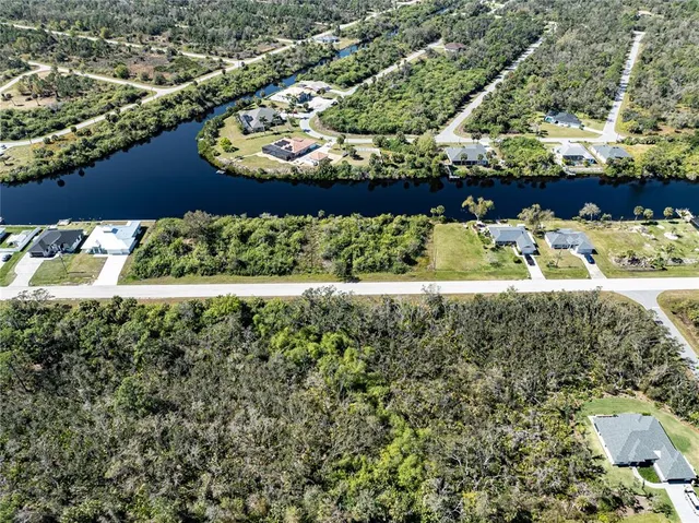 an aerial view of residential houses with outdoor space and swimming pool
