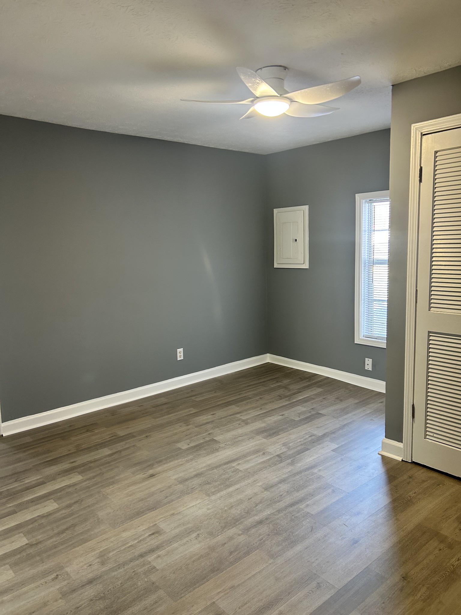 110 Demase Street Portland, TN 37148 - Photo 12 of 13 a view of an empty room with wooden floor and a window