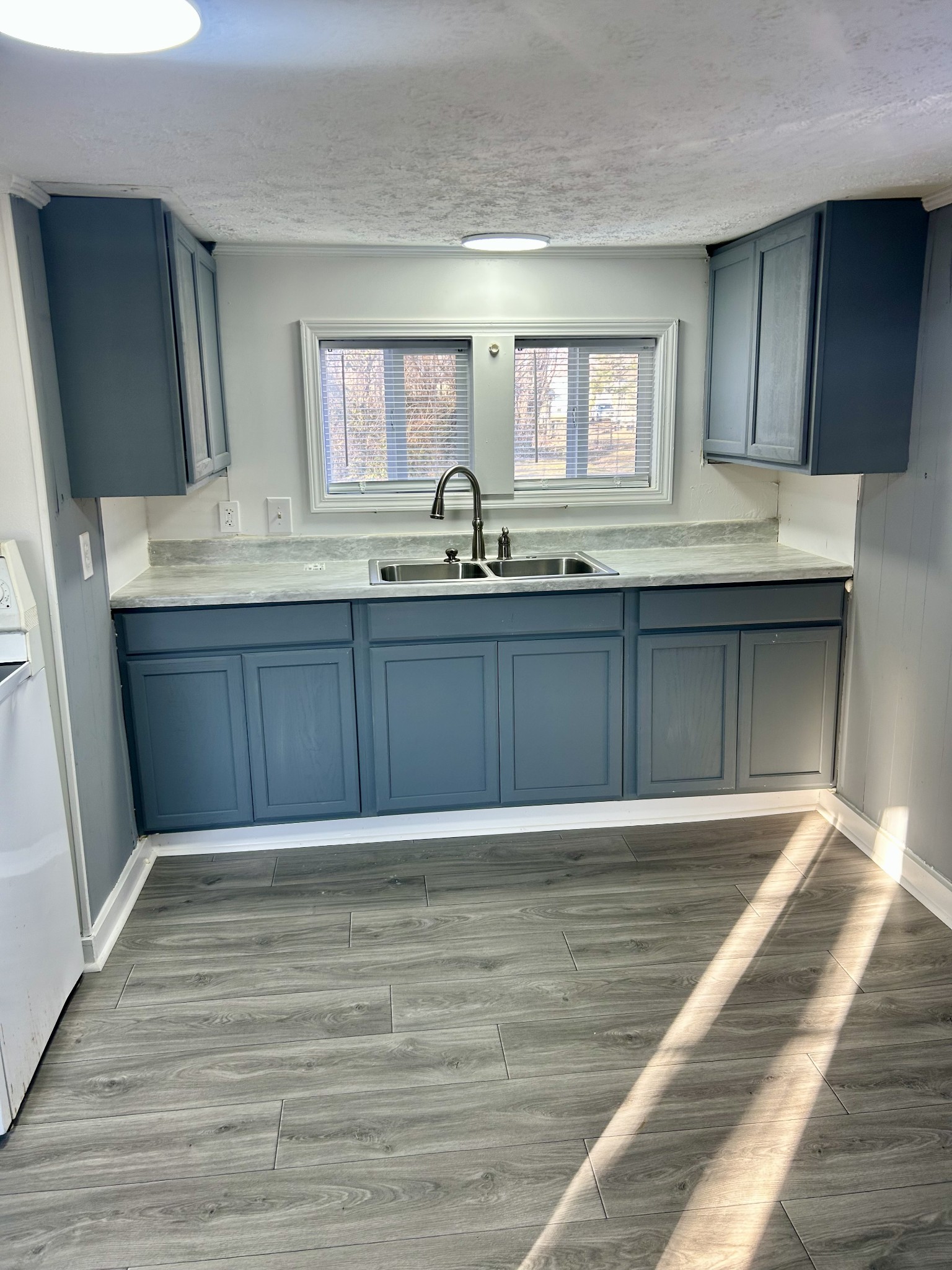 110 Demase Street Portland, TN 37148 - Photo 13 of 13 a view of a kitchen with granite countertop cabinets a sink and a wooden floor