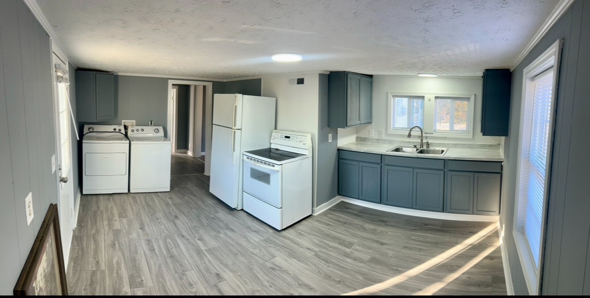 110 Demase Street Portland, TN 37148 - Photo 2 of 13 a kitchen with a sink refrigerator and cabinets