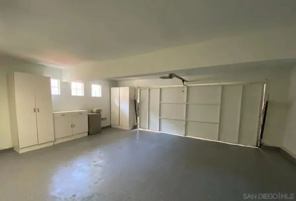 an empty room with a empty space and windows